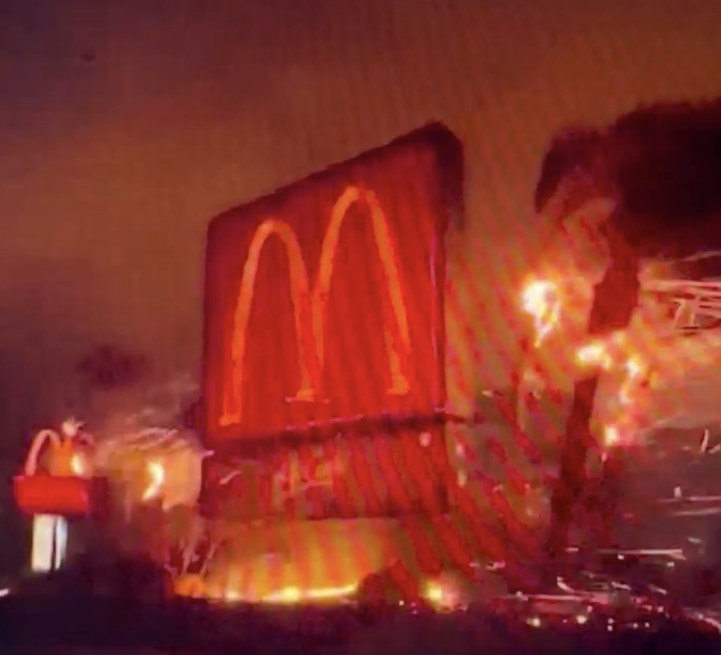 fires rage around a McDonald's sign